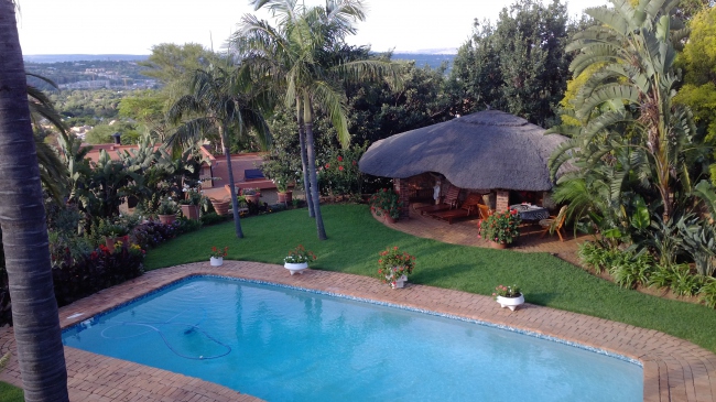Panorama-Blick von den Gästezimmern über Pool und Teile der Gartenanlage auf die Gartenstadt Pretoria und Umgebung - Südafrika - 